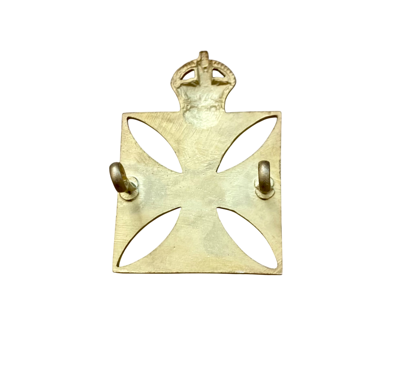 Reverses side of gold cross badge with a crown on a white background