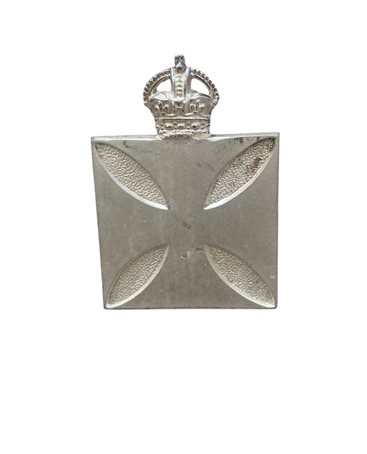 Silver badge with a cross design and crown on a white background